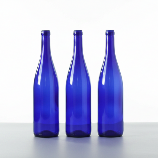 Three blue glass bottles on a white background