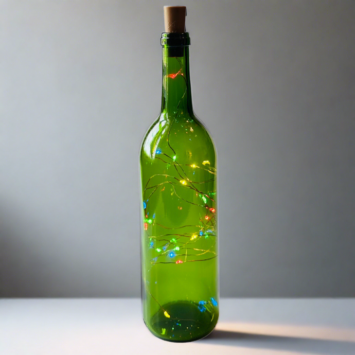 green wine bottle with colored fairy lights inside