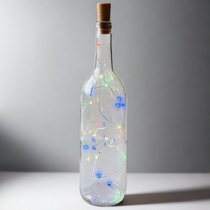 Clear Wine Bottle With Bright Colored Battery Operated Lights Powered From Cork